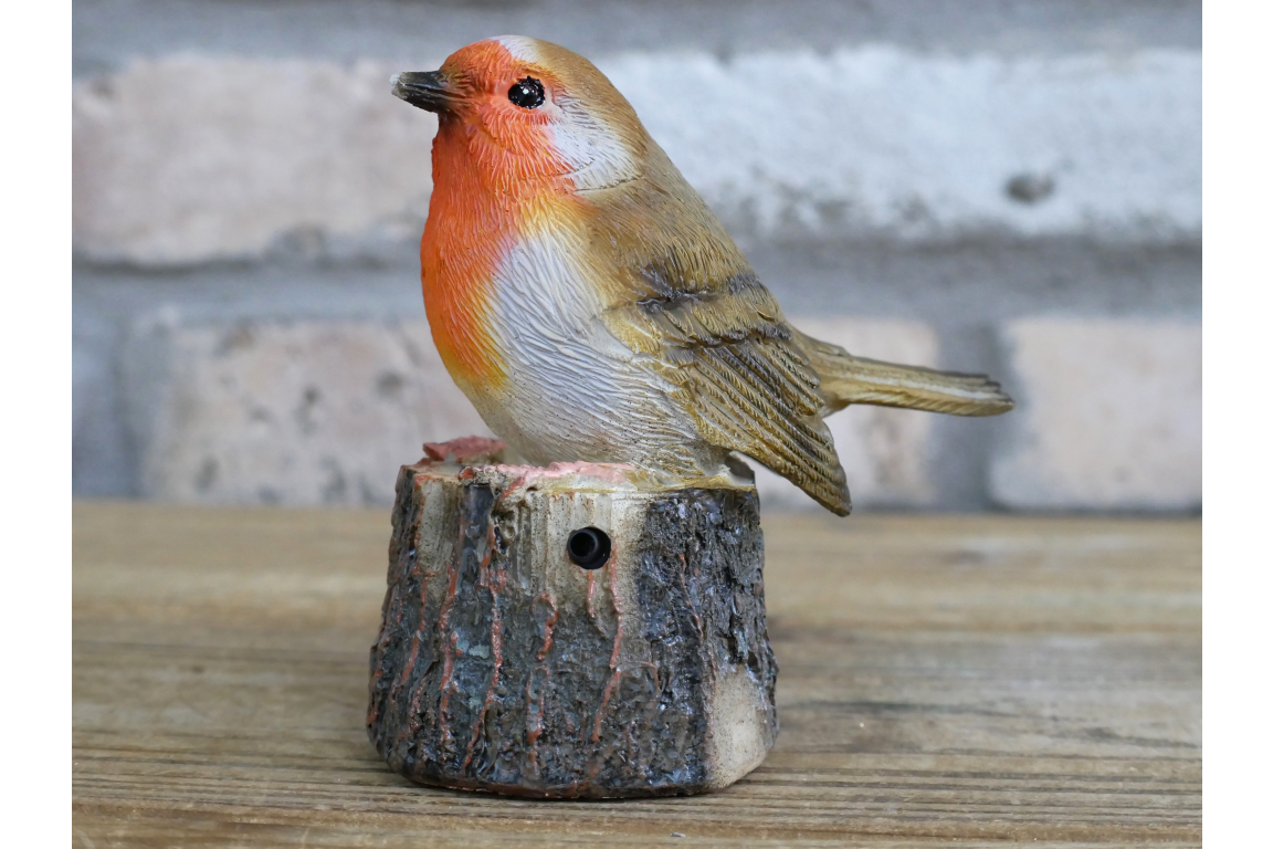 tweeting Robin on a log statue for the garden sensor activated