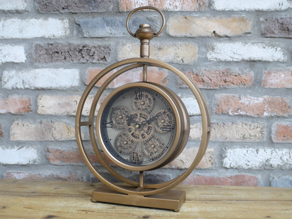Round gold clock with moving cog detail