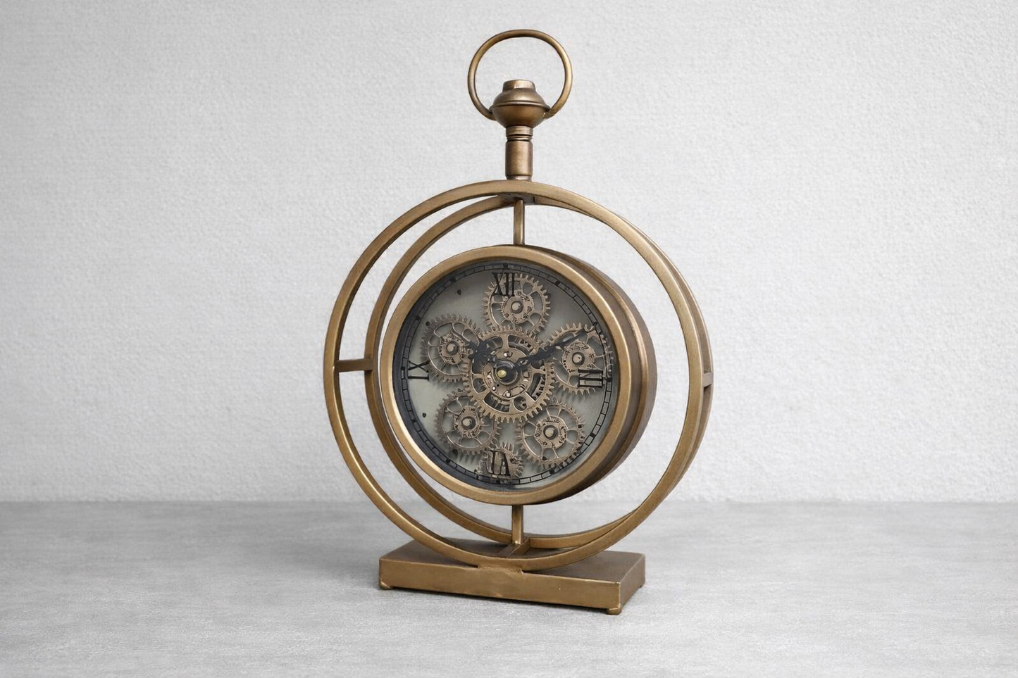 Round gold clock with moving cog detail