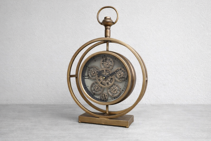 Round gold clock with moving cog detail