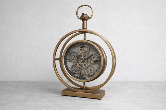 Round gold clock with moving cog detail