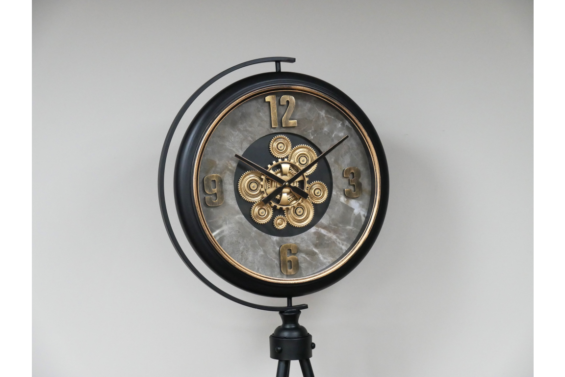 Black and gold industrial moving cog clock on a stand