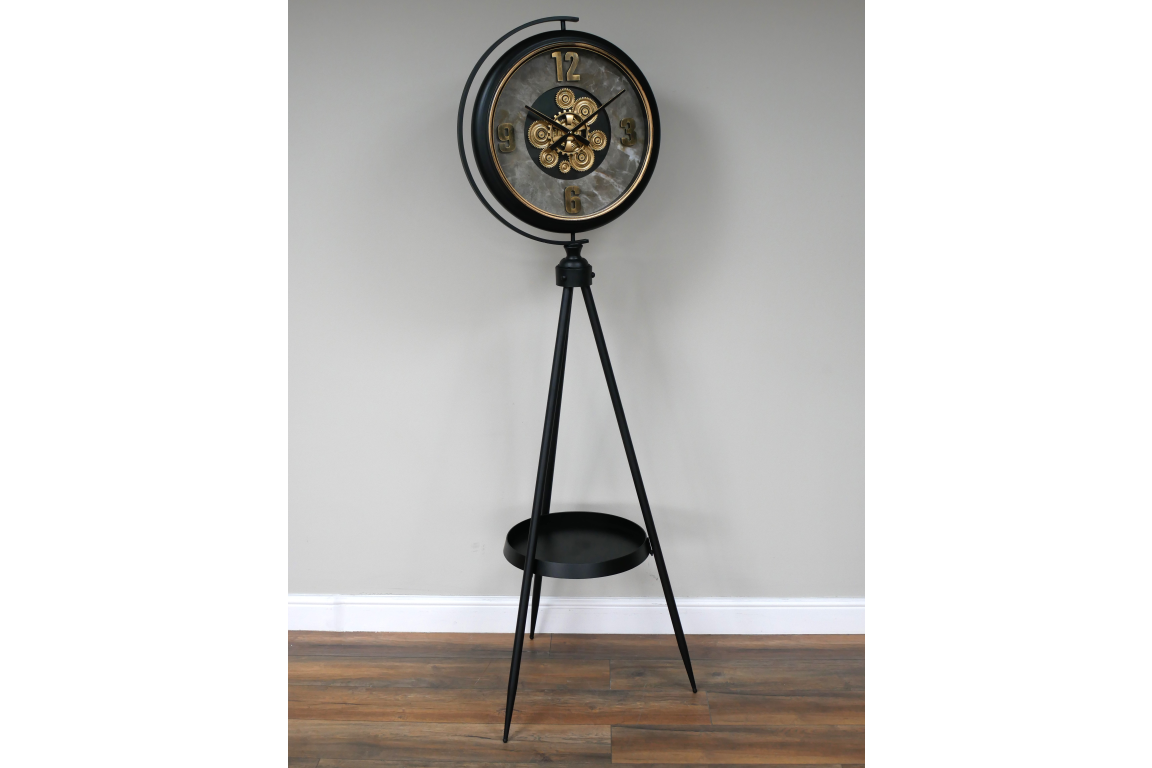 Black and gold industrial moving cog clock on a stand