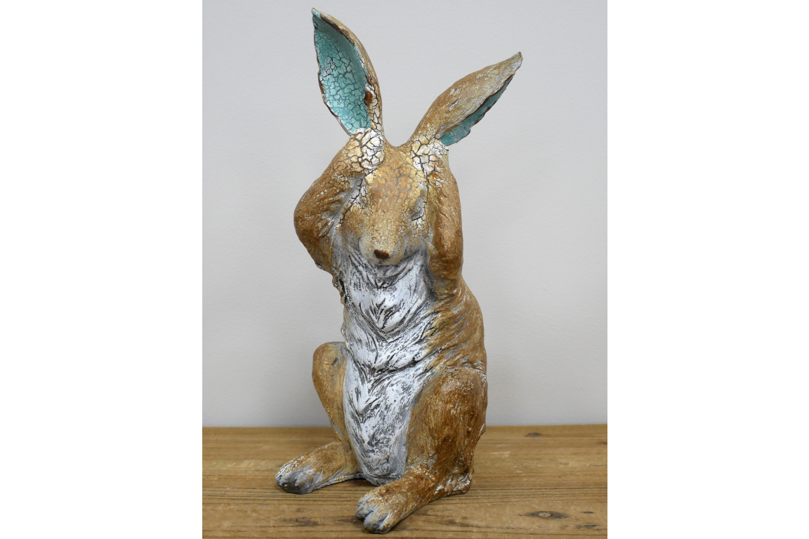 Rustic rabbit statue with hands over ears , for home or garden