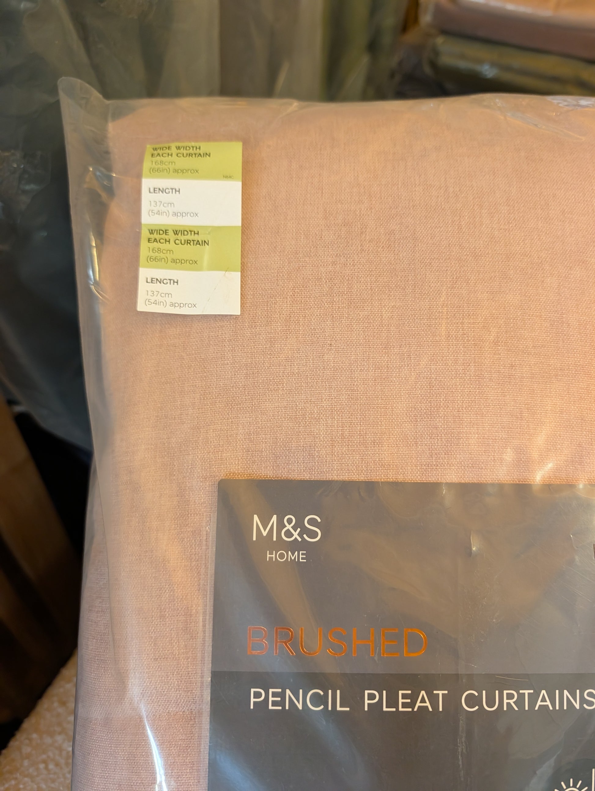 M&S Home Brushed Pencil Pleat Curtains in a light peach-beige color, packaged in a clear plastic bag with a product label and size sticker.